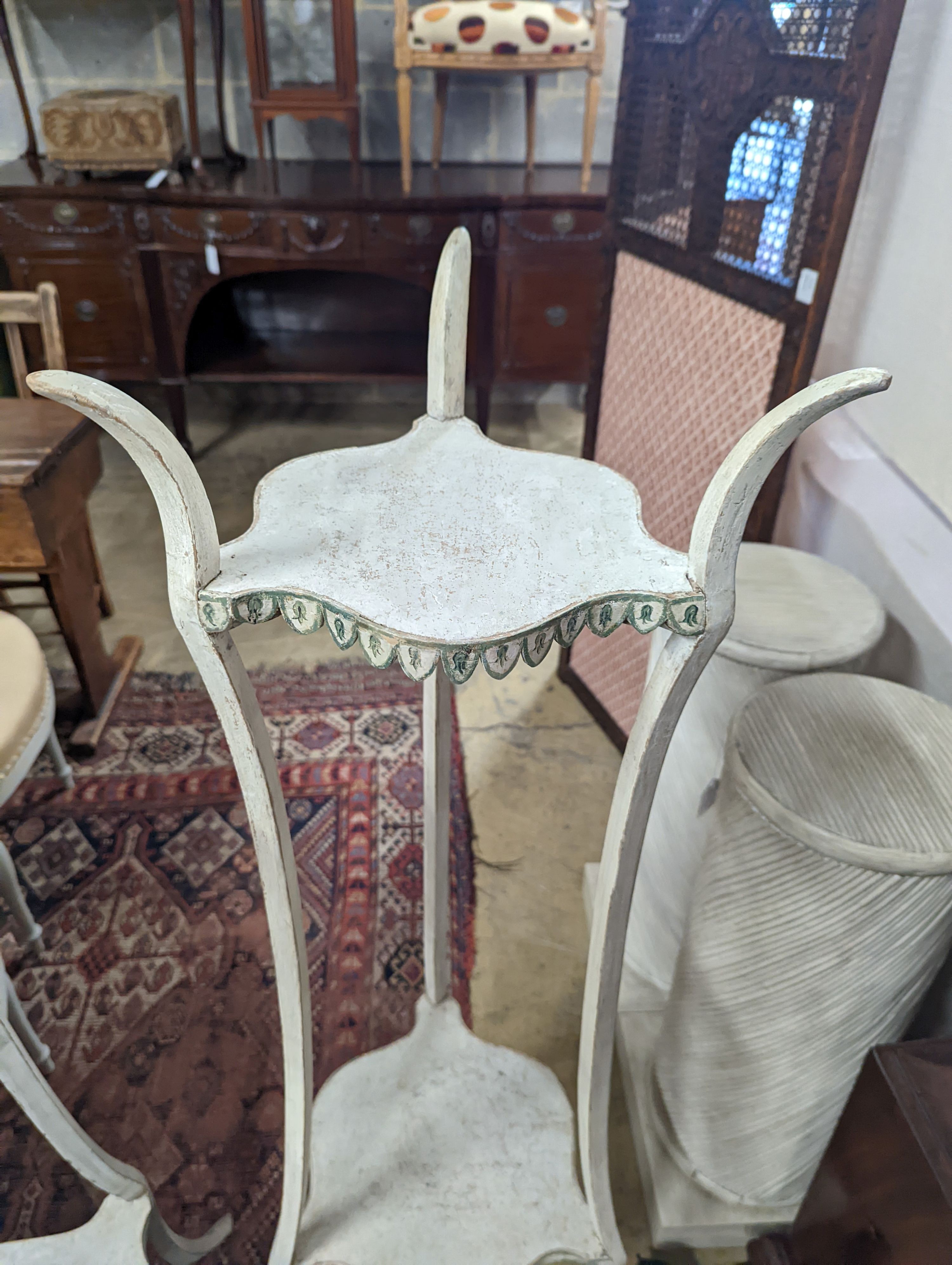 A pair of two-tier white painted plant stands, Colefax & Fowler, height 131cm